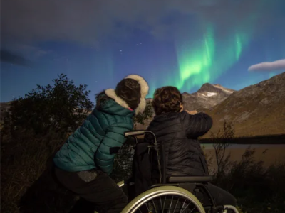 Northern-Lights-in-Norway two people watching the northern lights