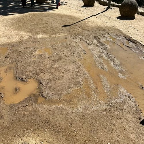 puddle leading to a muddy gravel path puddle leading to a muddy gravel path